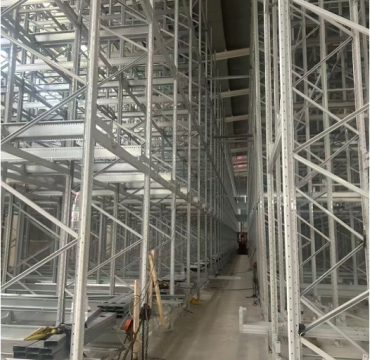 Automated high-density warehouse using a Four-Way Pallet Shuttle System for pallet storage and retrieval