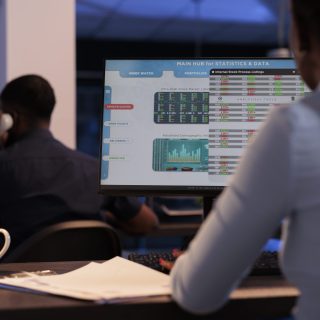 Woman broker looking at real time stock market sales, analyzing global trade exchange statistics for capital money investment. Working with hegde fund index profit on forex trading at night.